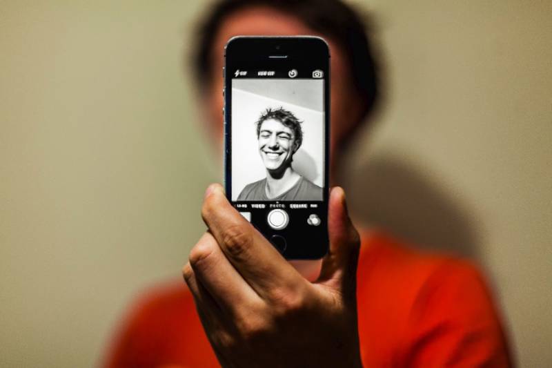 person taking a selfie with a black and white filter