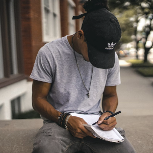 person jotting down notes in a notebook