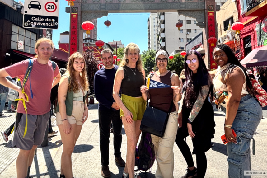  A group of San Diego Mesa College students and faculty stand together under a traditional Chinese archway with red lanterns in the Chinatown district of Buenos Aires, Argentina.
